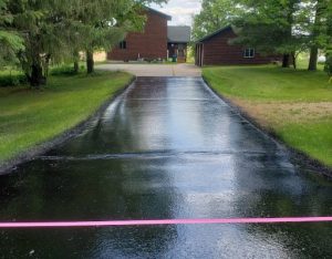 Driveway with wet sealcoating on it.